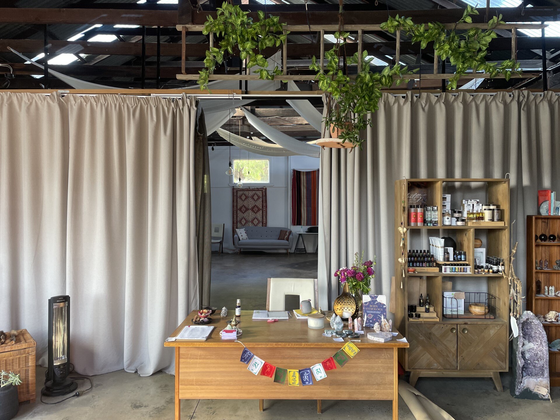 The interior of a building with a front desk set up, large curtains and decorated. 