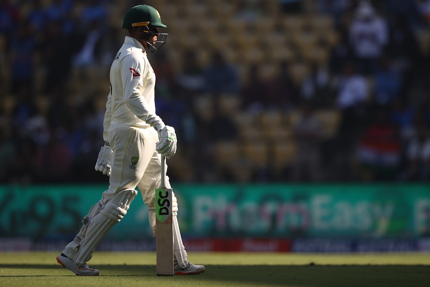 An Australian male batter walks from the field after being dismissed against India in Nagpur.