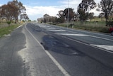 A damaged section of bitumen on the highway.