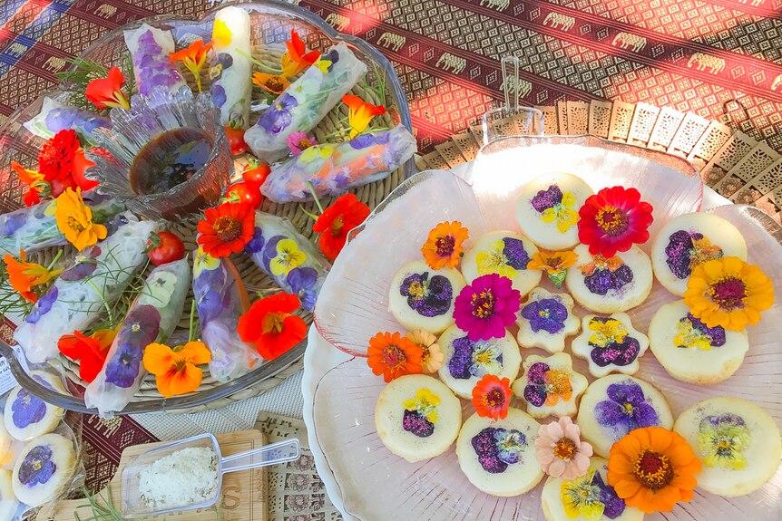 Biscuits and rice paper rolls covered in flowers.