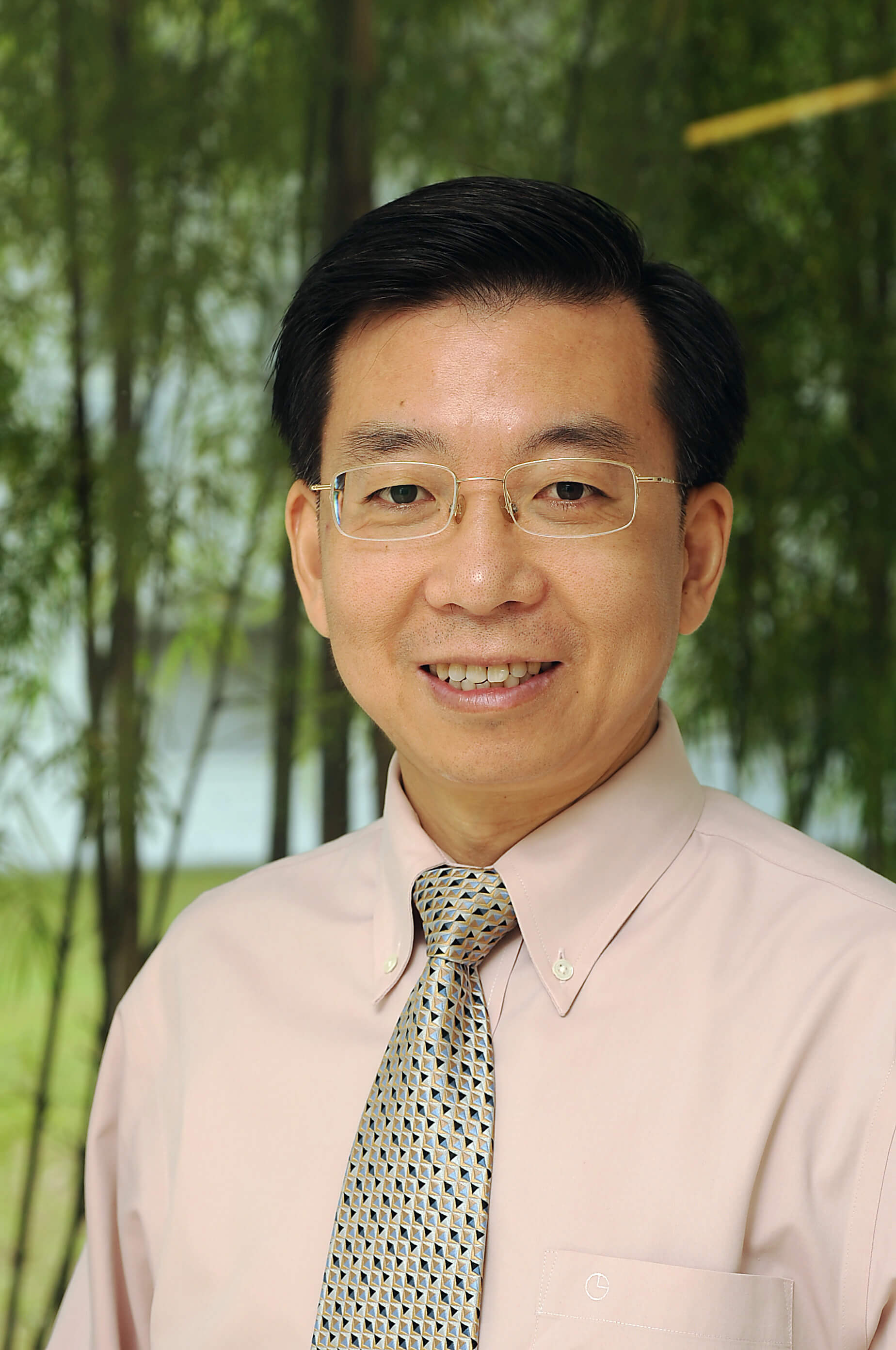 A man looks at the camera smiling.