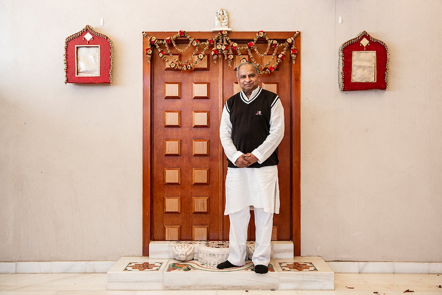 Jain community leader Nitin Doshi standing in front of the temple he built in his backyard.