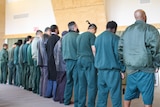 Inmates at Hopkins Correctional Centre in Ararat lining up for prayer service.
