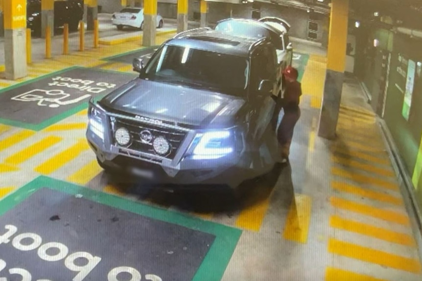 CCTV footage shows a woman in a red hat entering the passenger side of a four-wheel drive.
