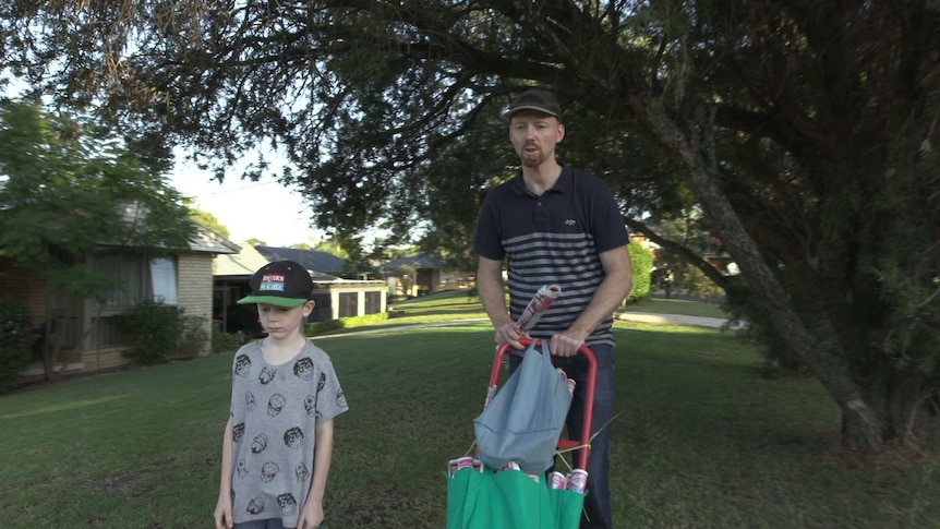 Julian Evans and one of his sons delivering newspapers