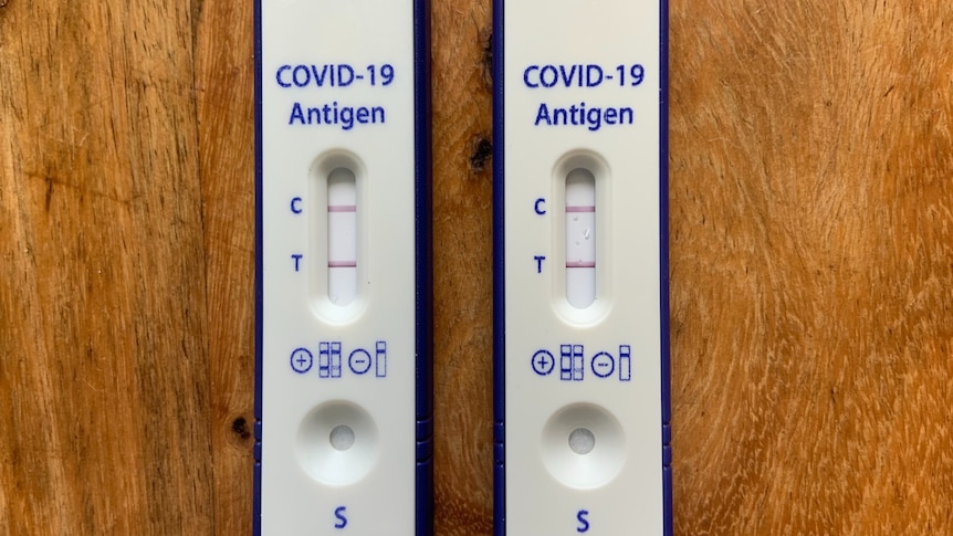 Two rapid antigen tests showing positive results for COVID-19