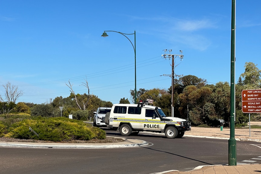 A South Australian police vehicle at a roundabout.