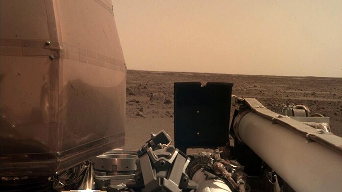 The InSight probe's second image, showing a desolate red plain.