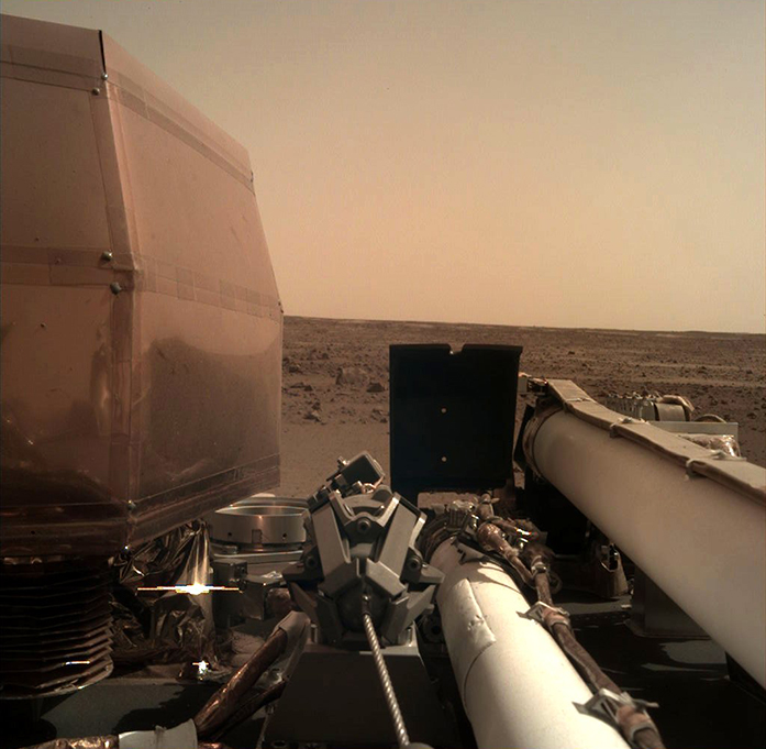 The InSight probe's second image, showing a desolate red plain.