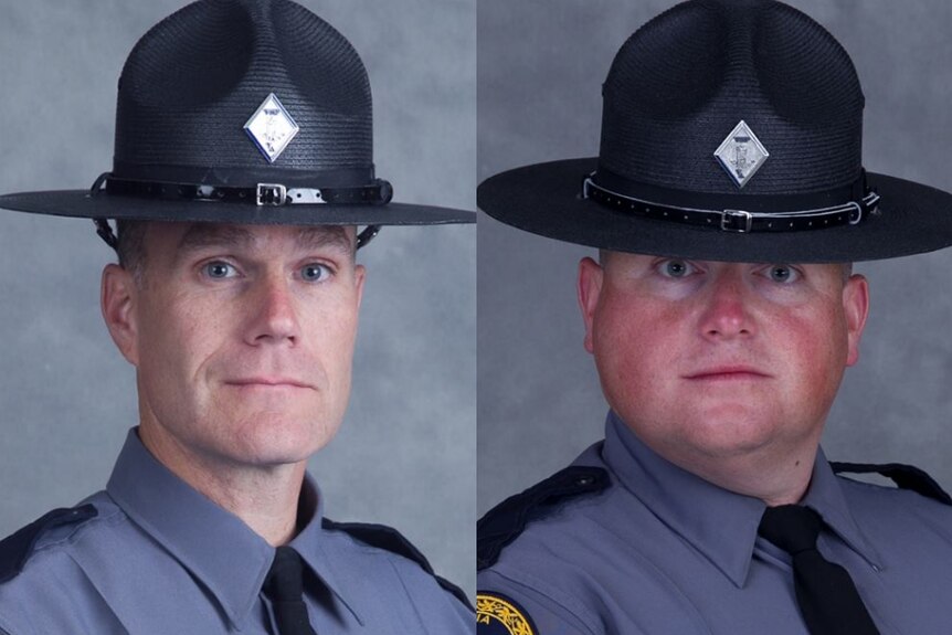 Virginia State Police officers H. Jay Cullen and Berke M.M. Bates wearing their grey uniforms and big black hats looking ahead