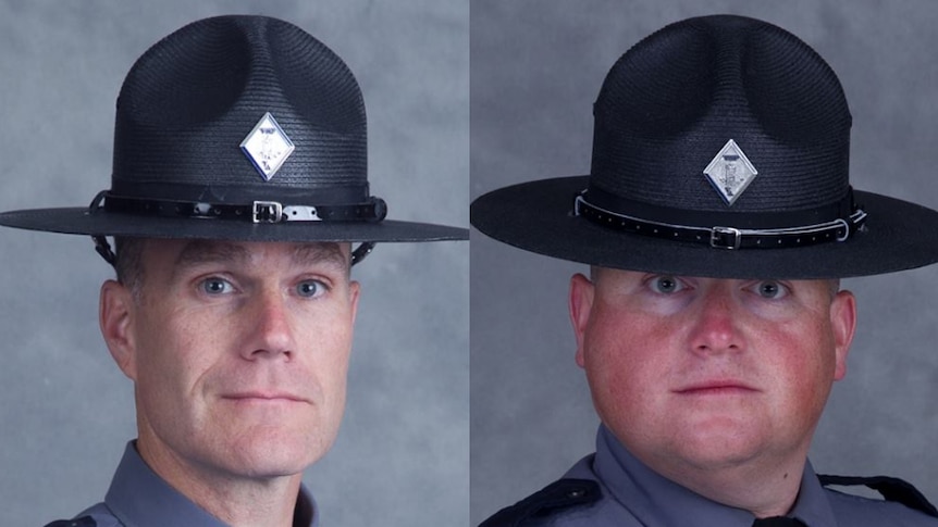 Virginia State Police officers H. Jay Cullen and Berke M.M. Bates wearing their grey uniforms and big black hats looking ahead