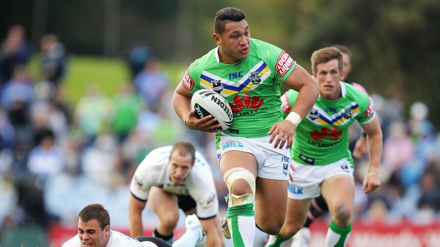 Canberra try-scorer John Papalii leaves the porous Sharks defence in his wake.