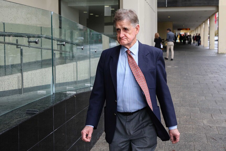 Tony Overheu walks along the footpathy outside Perth Magistrates Court.