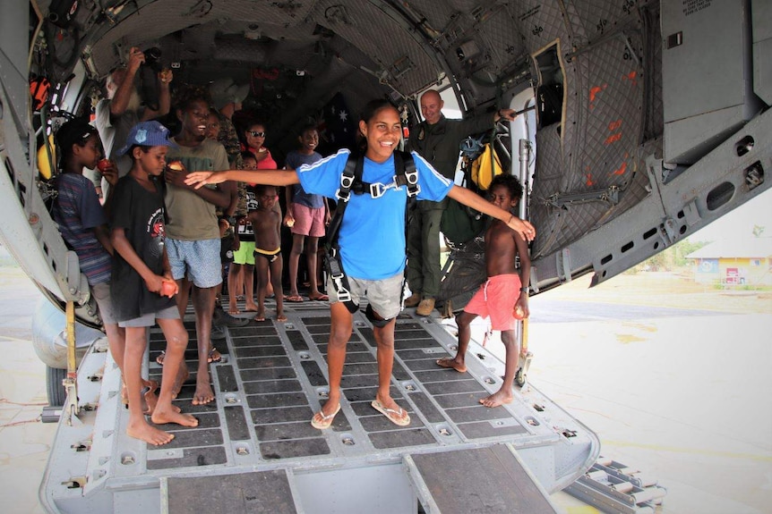 Aboriginal children inside a military aircraft.