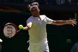 Roger Federer hits a running forehand against Damir Dzumhur