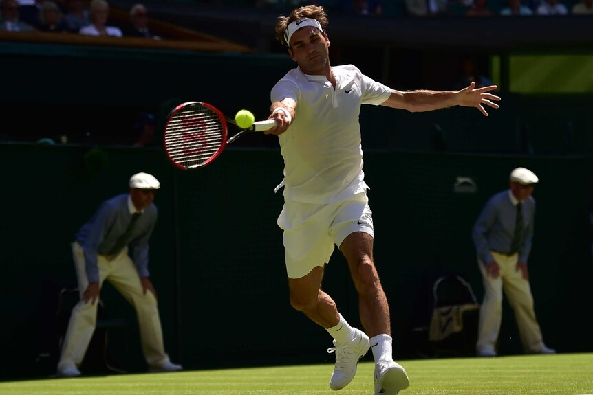 Roger Federer hits a running forehand against Damir Dzumhur