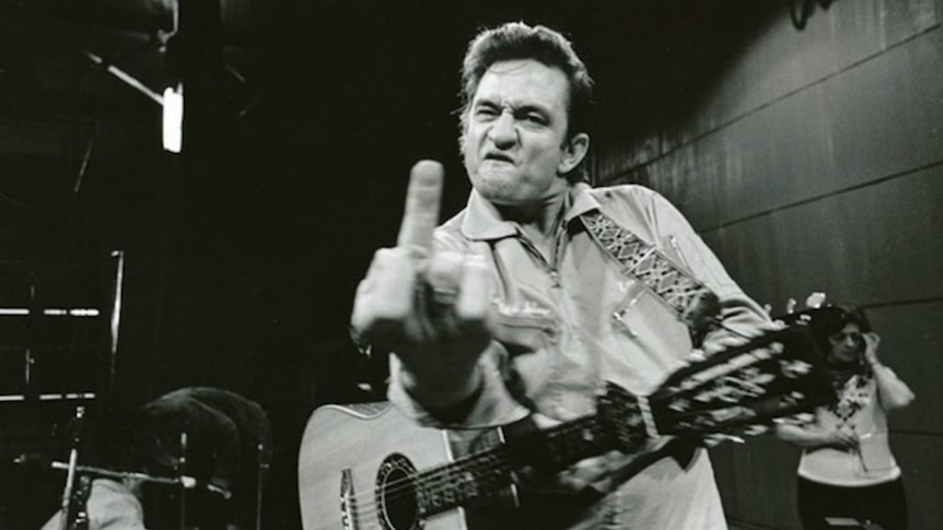 Johnny Cash holds up his middle finger