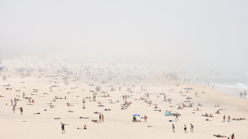 Fog sweeping over a beach full of people