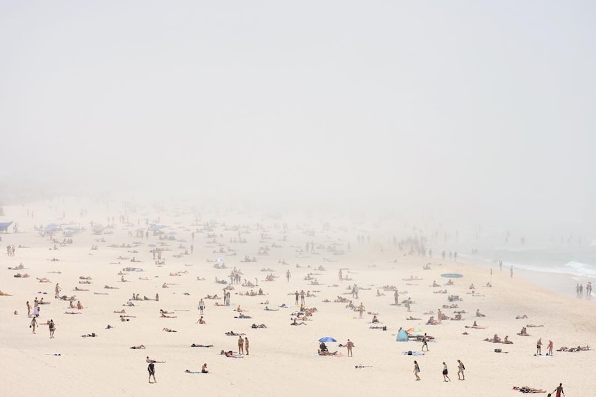 Fog sweeping over a beach full of people