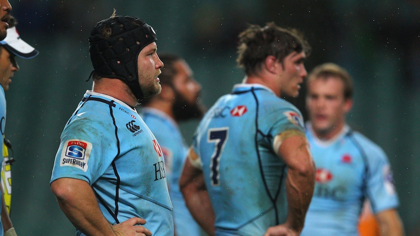 Night to forget ... Waratahs captain Benn Robinson (L) and his team-mates collect their thoughts