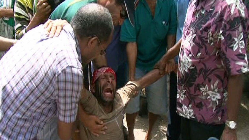 Relatives of the victims gathered at the Port Moresby airport as the bodies arrived.