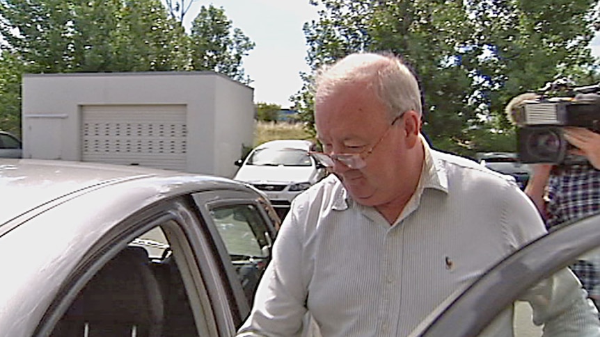 Video still: Lieutenant Commander John Alan Jones leaves the Australian Military Court