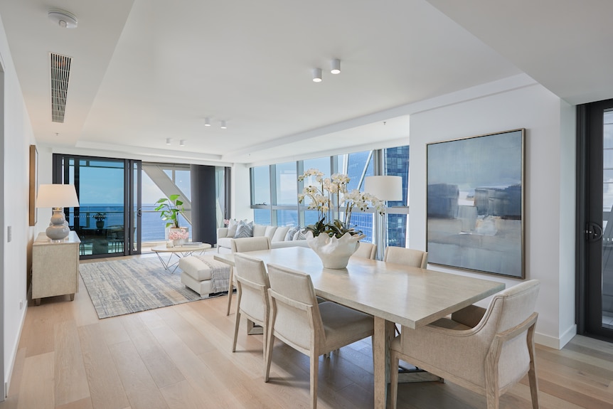 the living room of a furnished display apartment with views of the ocean