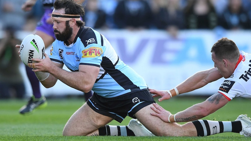 Aaron Woods falls forward with the ball in his hands to score a try.