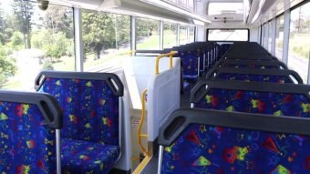 Empty seats on the top deck of a bus.