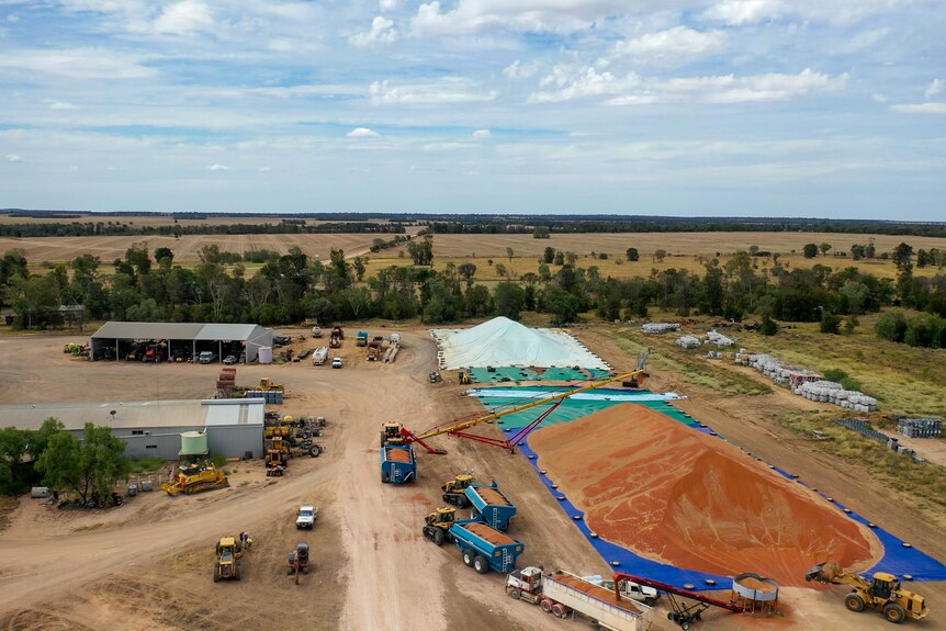 Aerial photo of a large pile of sorghum with machinery and sheds nearby, February 2023.