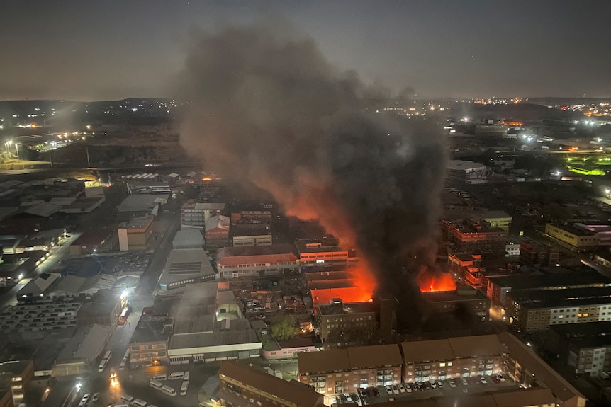 Smoke rises from a burning building amid a deadly fire, in Johannesburg, South Africa