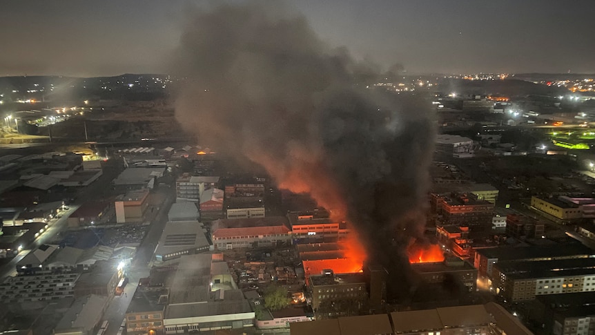 Smoke rises from a burning building amid a deadly fire, in Johannesburg, South Africa