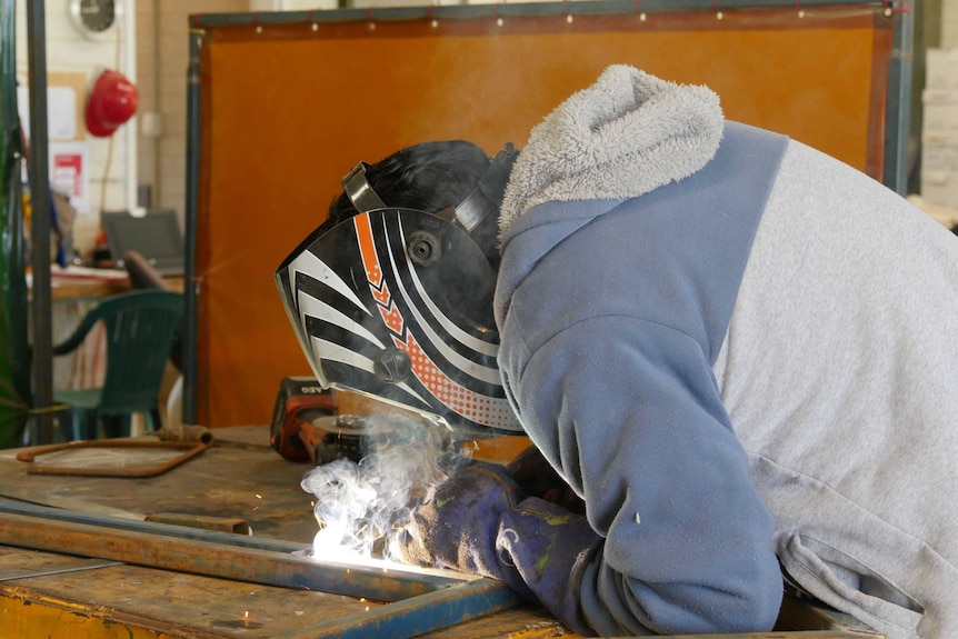 Nathan Douglas welding inside Santa Teresa CDP men's shed.