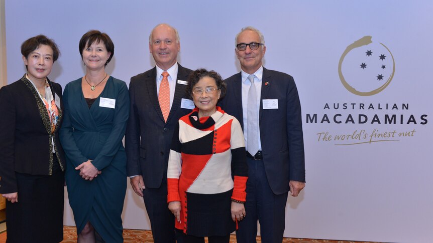 Australian Macadamia Society staff stand with two Chinese macadamia and nut executives.