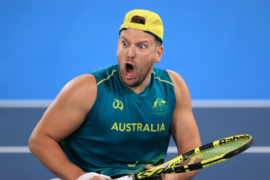 Tennis player reacts after winning gold at the Olympics