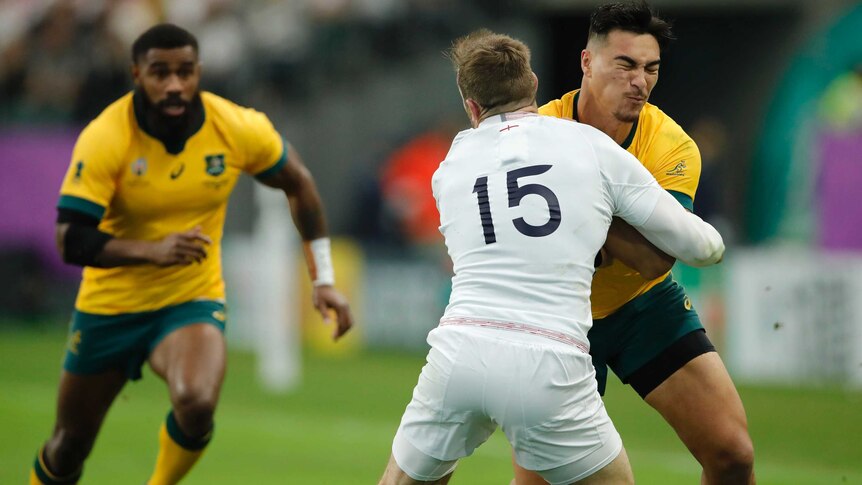 A rugby player hits another player in a front-on tackle in a game at a major tournament.
