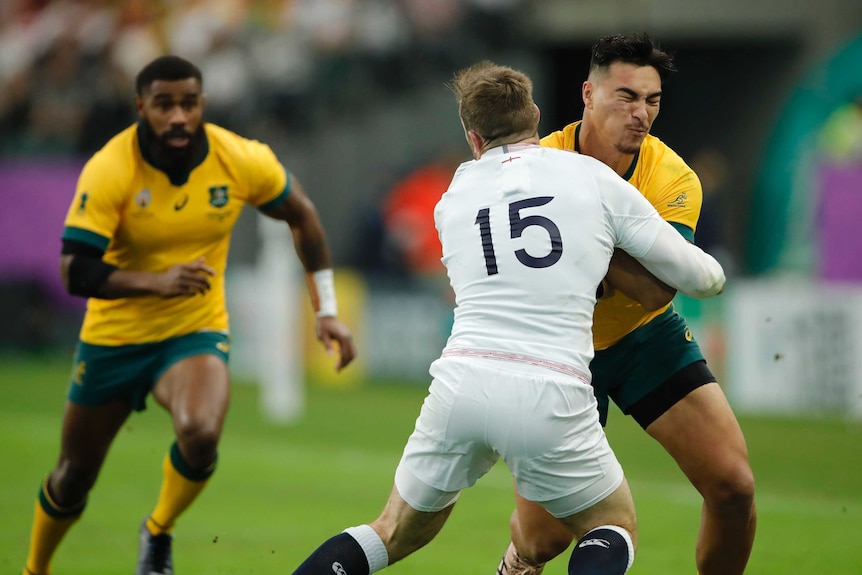 A rugby player hits another player in a front-on tackle in a game at a major tournament.