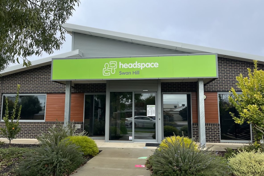 A building with a green headspace sign.