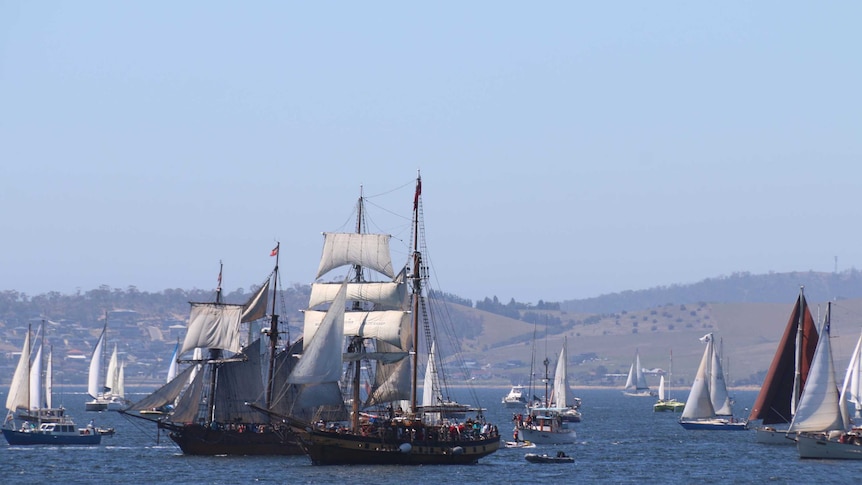 Ships take part in a sail past on the River Derwent during the Australian Wooden Boat Festival.