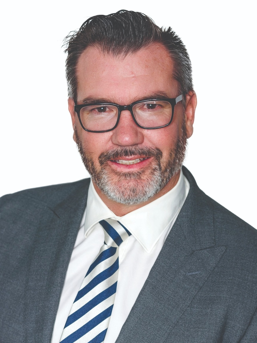 Man in glasses and suit in head shot photo