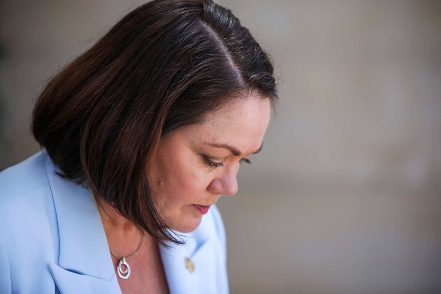 A photo of Liza Harvey looking down.