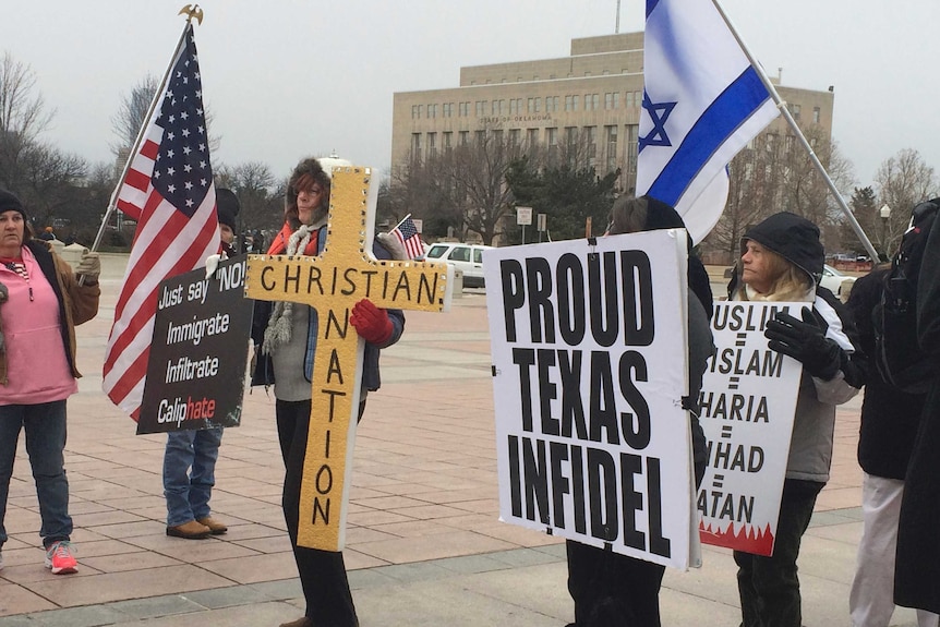 Anti-Islamic protesters hold signs during a demonstration outside the Capitol in Oklahoma City, 2015.