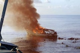 Asylum seekers struggle in the water near their exploded boat.