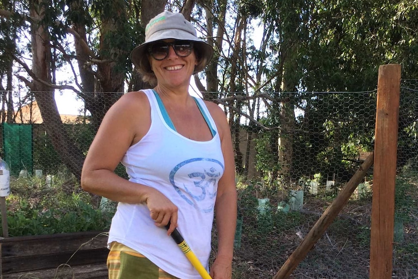 Denis Juelicher raking in the garden, which she helped found.