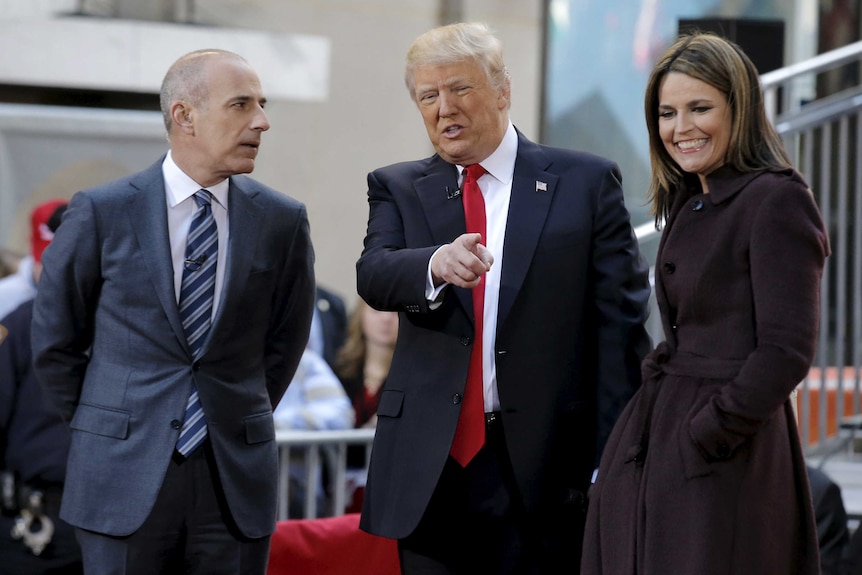 Matt Lauer, left, speaks to Donald Trump, centre, and Savannah Guthrie, right.