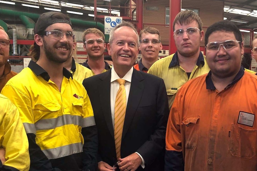 Bill Shorten surrounded by workers at a Perth factory.