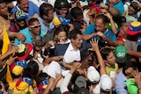 Venezuelan opposition leader Juan Guaido surrounded by a crowd of supporters.