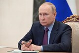 Russian President Vladimir Putin chairs a meeting