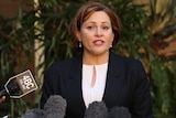 Queensland Treasurer Jackie Trad speaks into microphones.