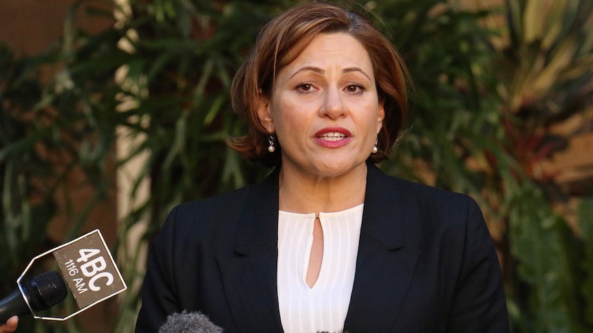 Queensland Treasurer Jackie Trad speaks into microphones.